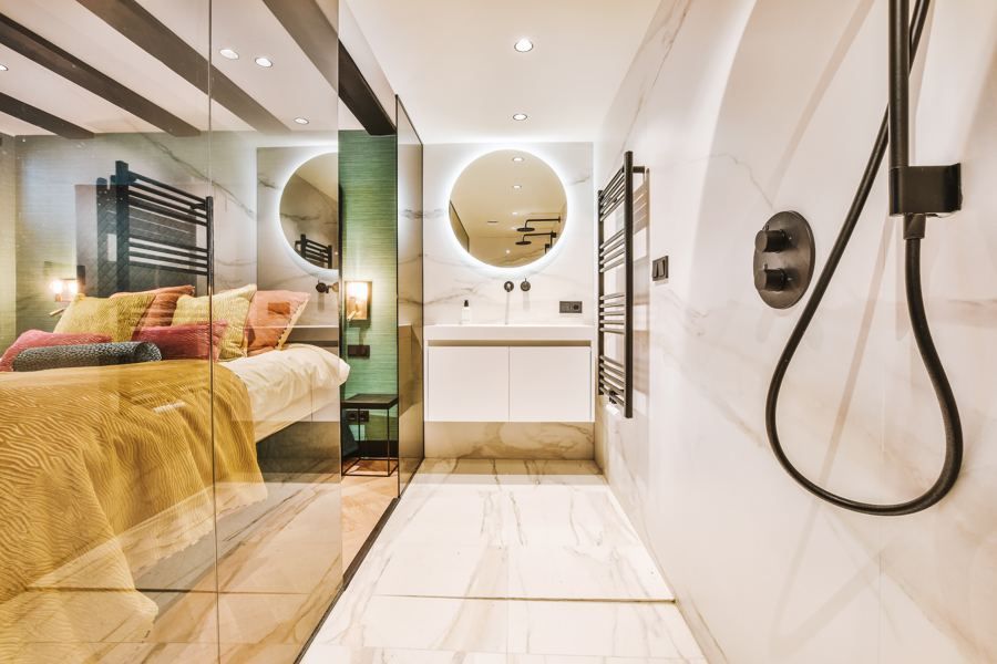Open primary suite with glass partition
