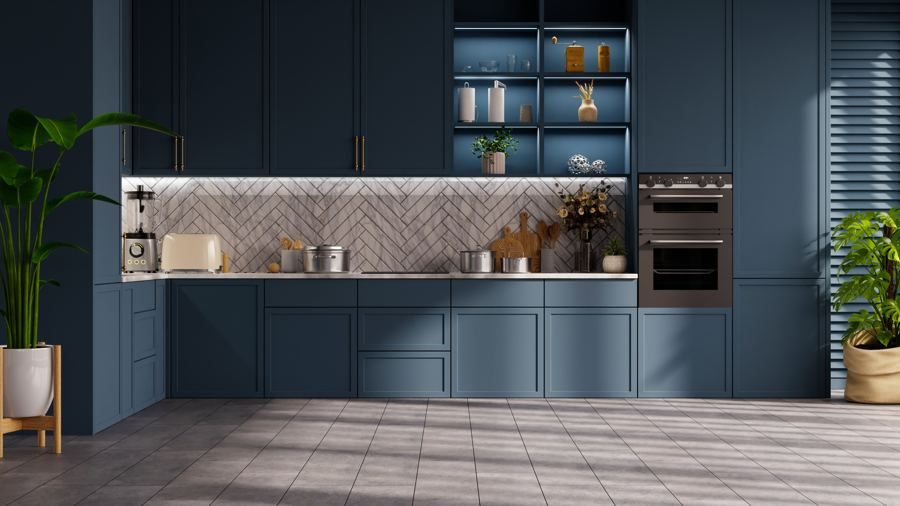 Navy shaker kitchen with marble herringbone backsplash and brass hardware